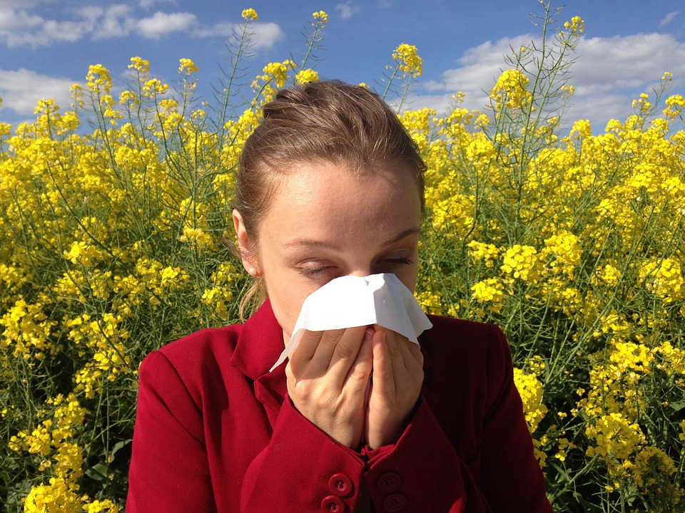 A young woman having an allergic reaction from pollen