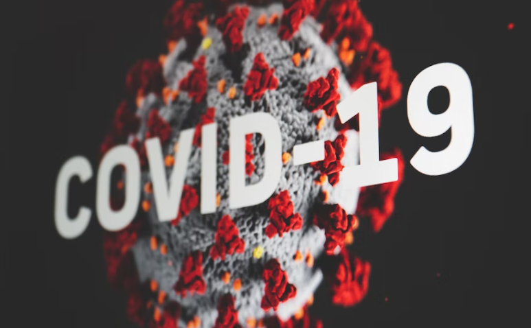 COVID-19 written over an image of the virus.