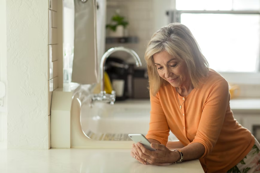 A woman talking to a telehealth doctor on a smartphone