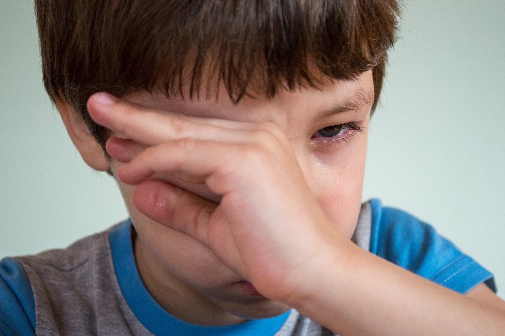 Child covering his eye