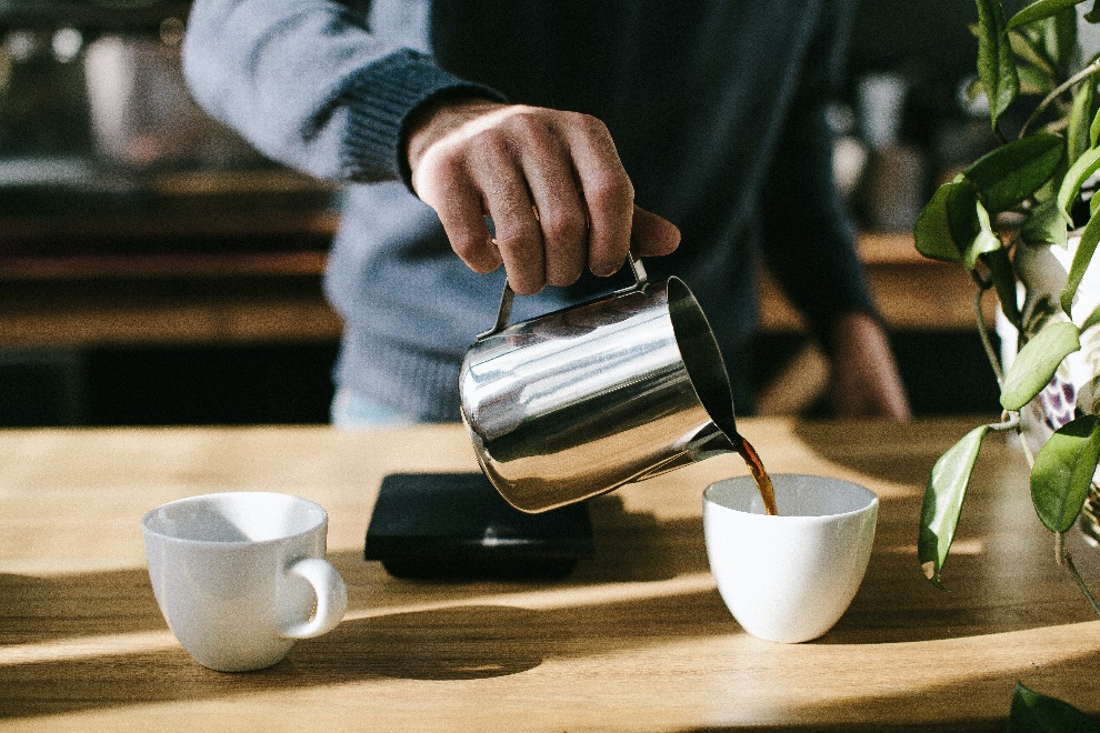 Man pouring coffee in a cup