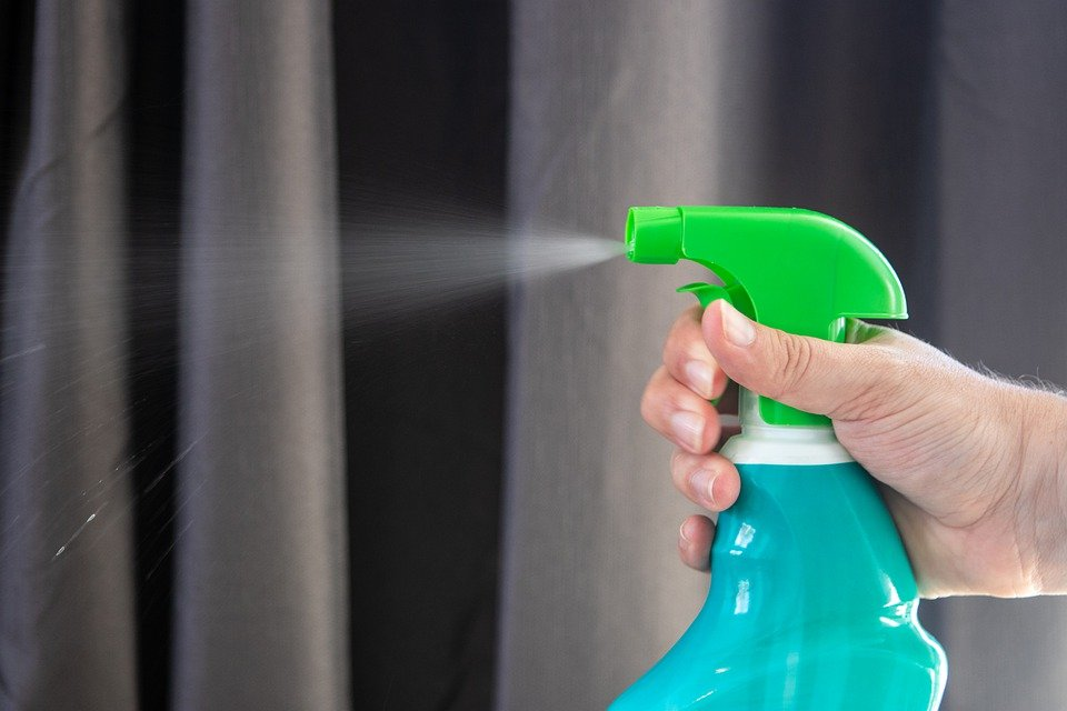 A person disinfecting