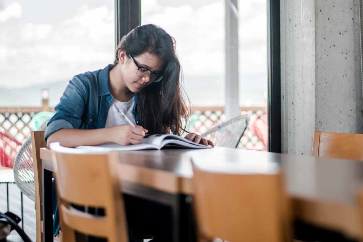 Student writing in a workbook