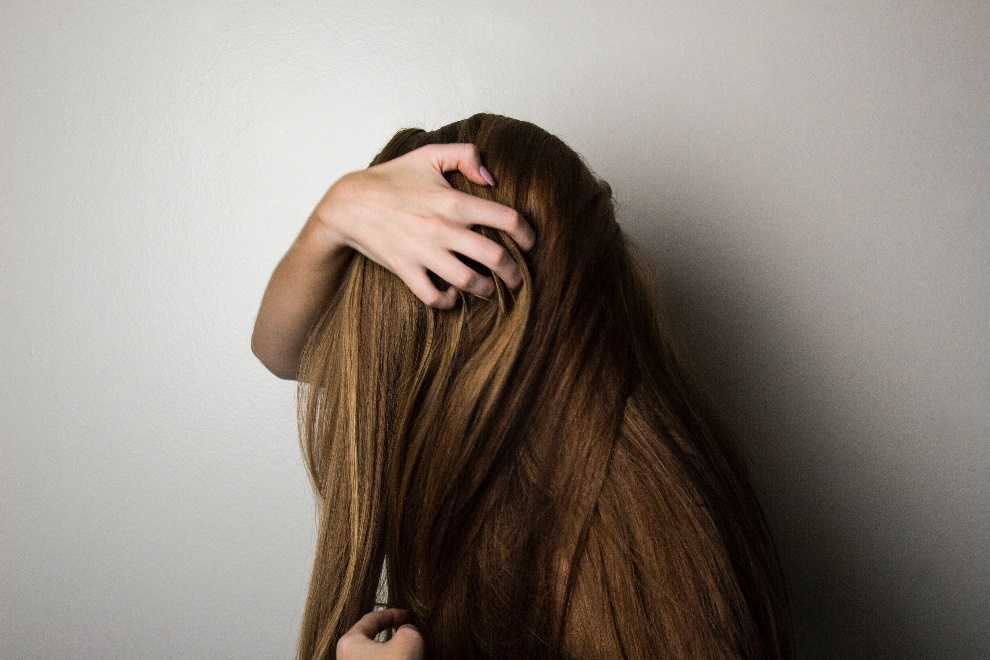 woman with her hair covering her face