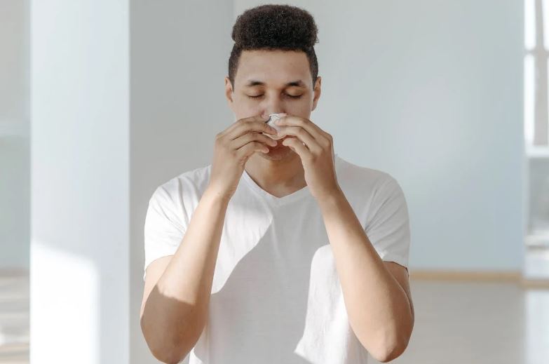Man wiping his nose