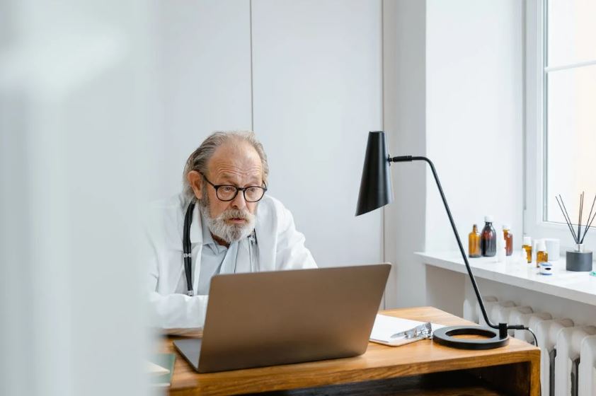 A senior doctor providing online consultation for ear infection