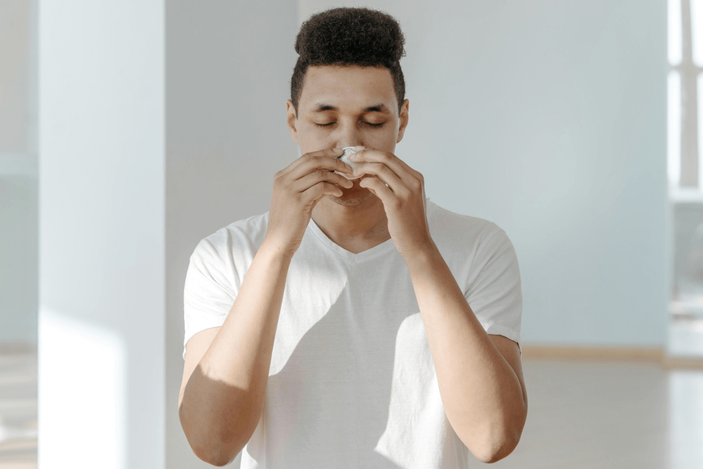 A man blowing his nose 