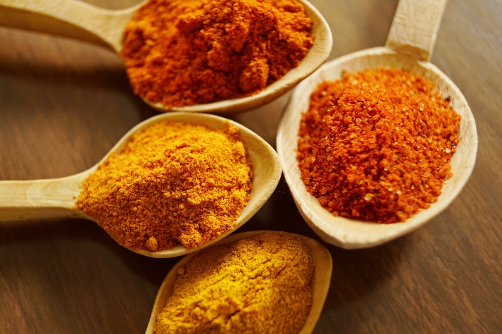 Turmeric and other spices in spoons
