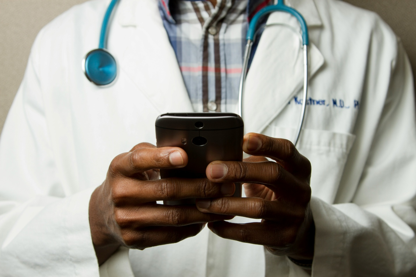 A virtual doctor checking his smartphone