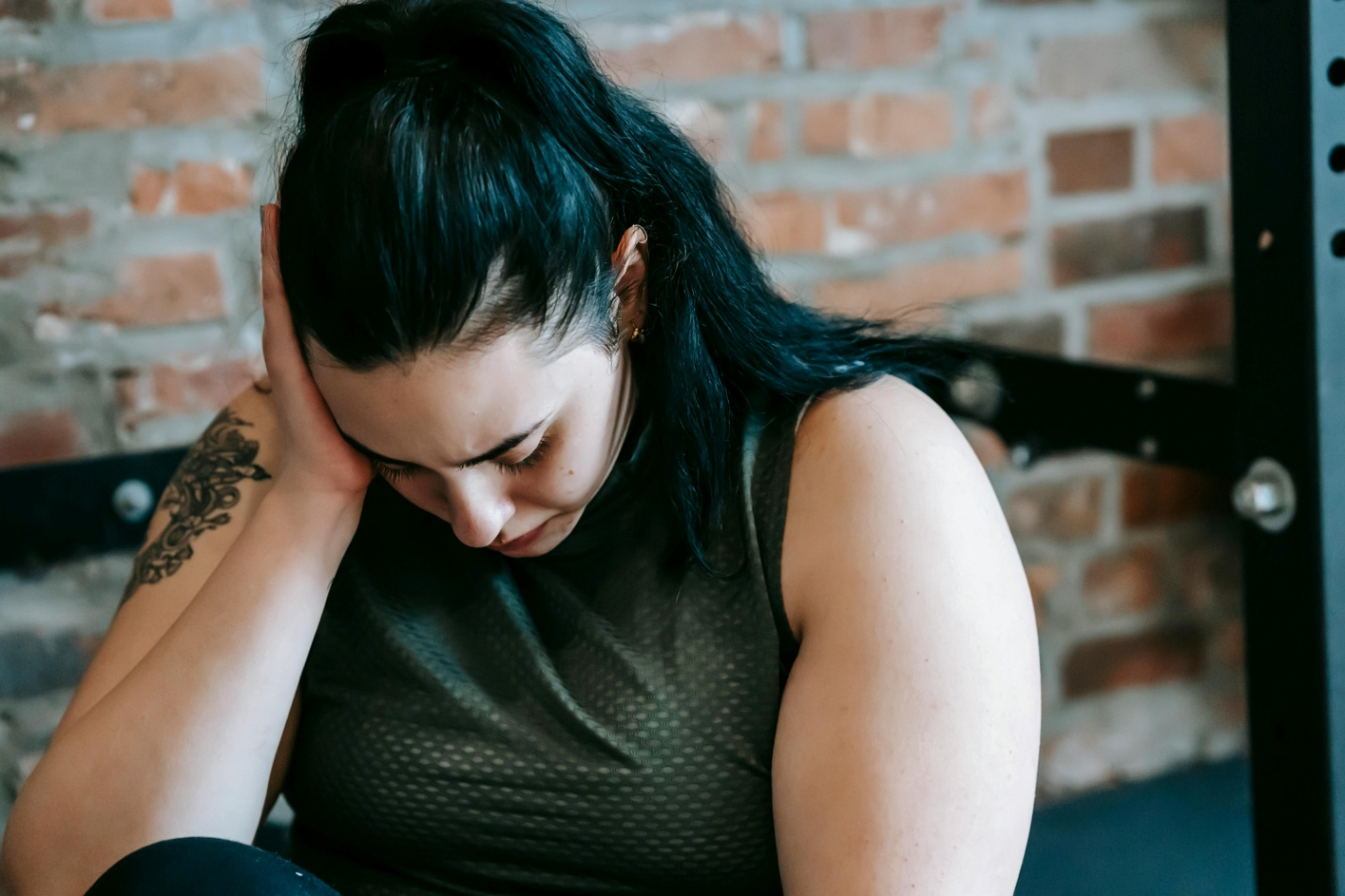 A stressed woman wearing a tank top