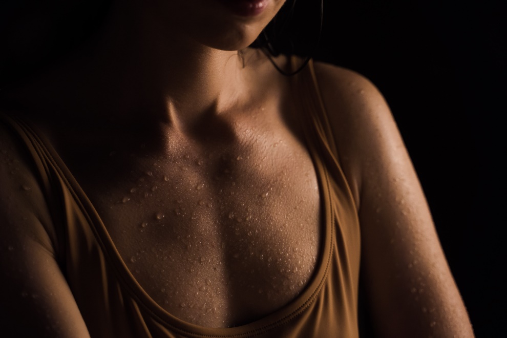 Beads of sweat on a woman’s chest