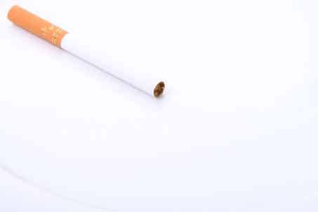 A cigarette on a white surface