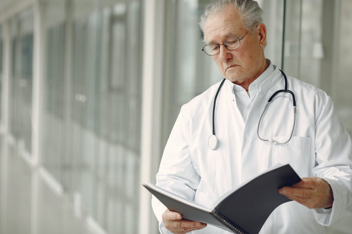 A doctor reading a medical record