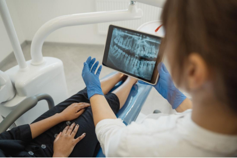 Dentist showing a dental x-ray to patient