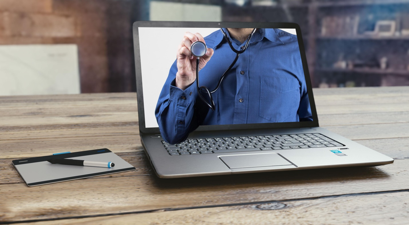 Illustration of a doctor's stethoscope reaching out through the laptop