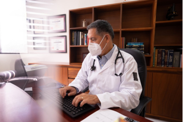Doctor with a stethoscope working on a computer