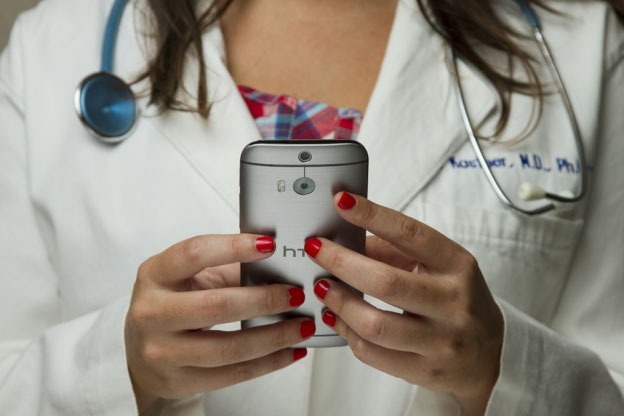 a doctor holding a phone