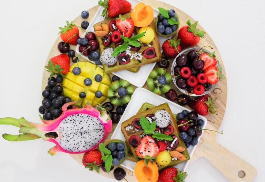 Assortment of fruits on a wooden board.