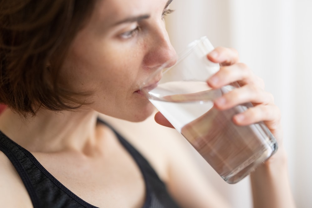 A closeup of a woman drinking water