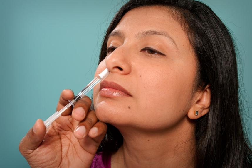 A female patient undergoing nasal spray treatment
