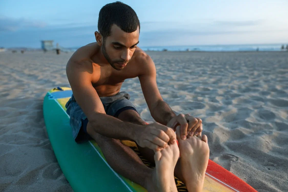 Person holding their toes