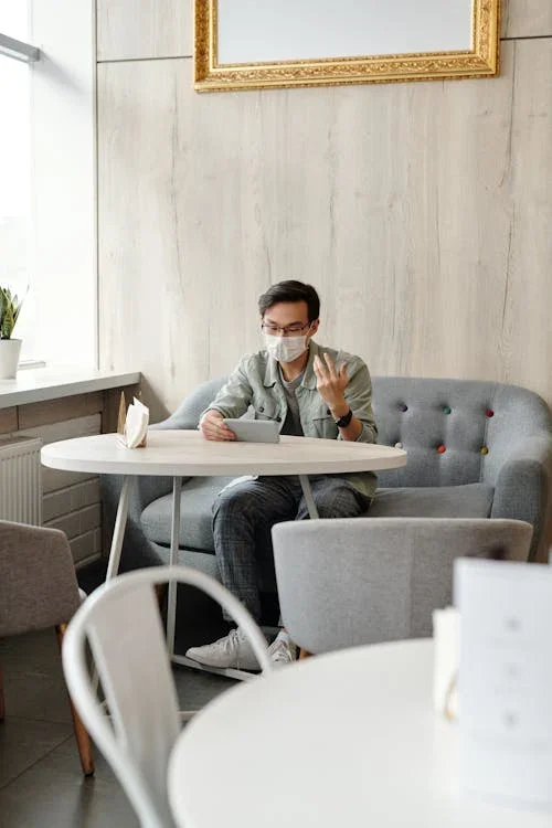 Man wearing a mask having a video call