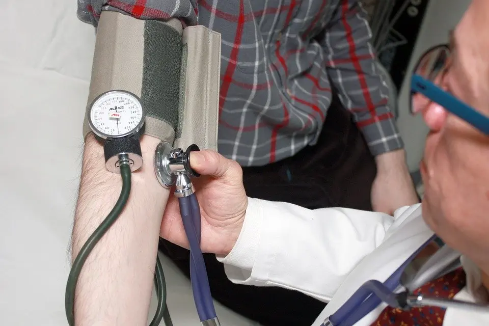 A doctor noting down a person’s vitals