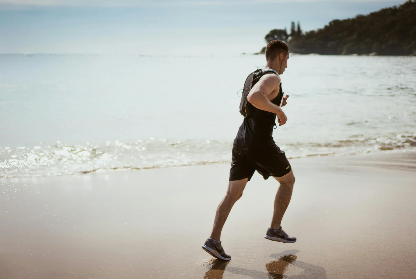 A man jogging on the beach 