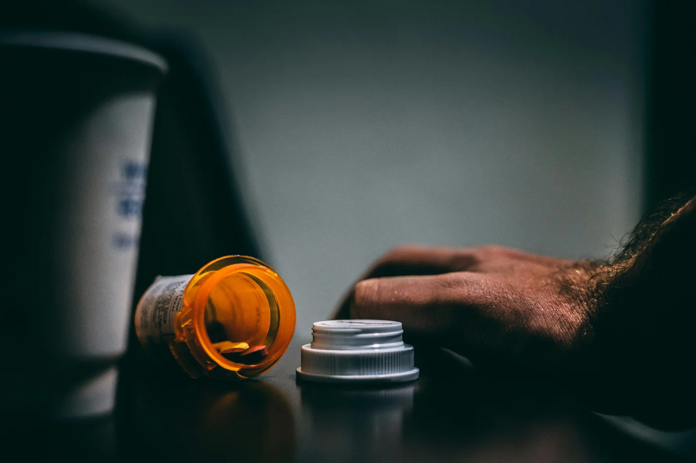 An open prescription bottle on a table