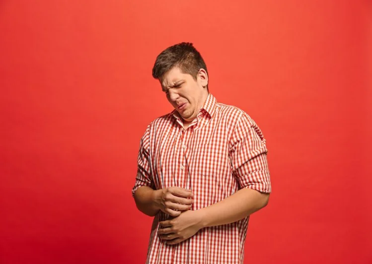 Man holding his stomach in pain due to GERD