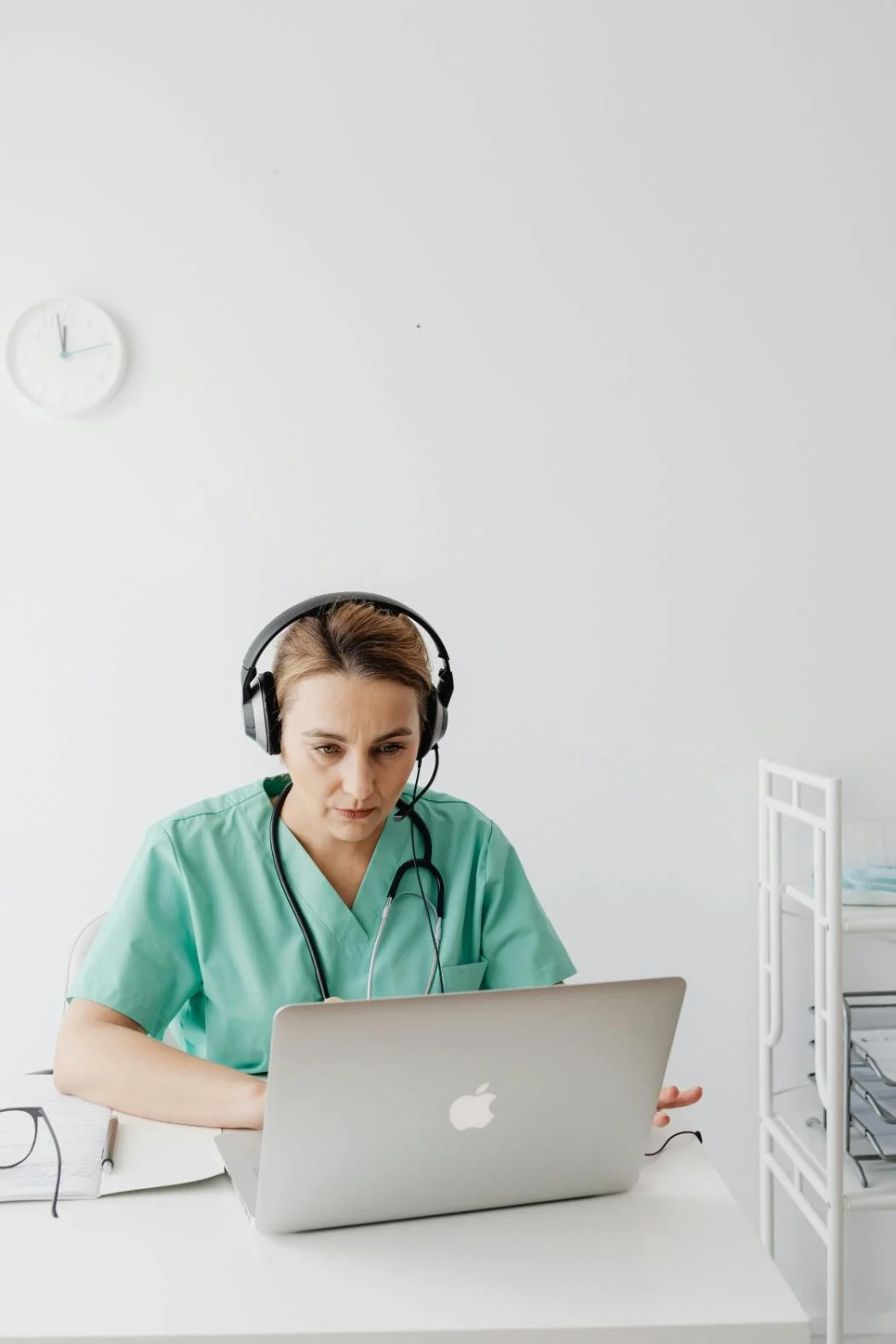 A doctor providing online consultation on a laptop.