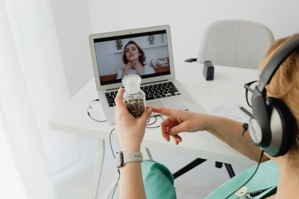 A person having an online consultation with a doctor on a laptop.