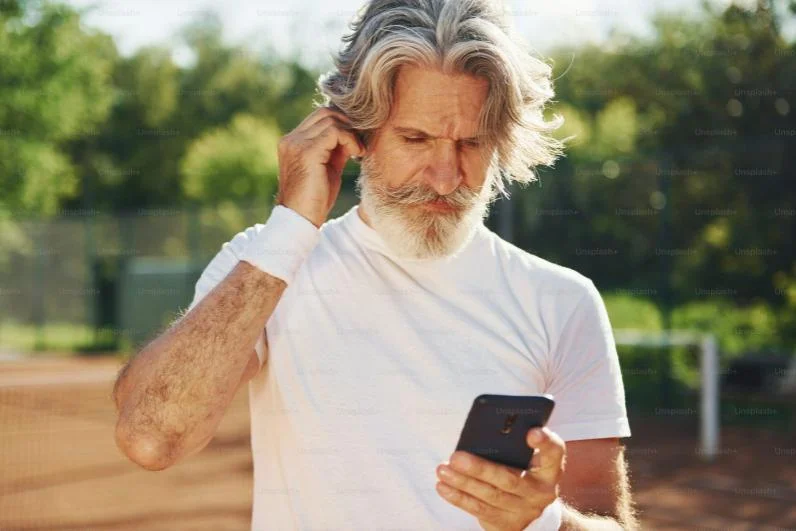 An image of a man looking at his phone