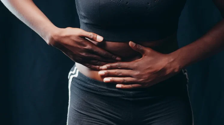 Woman holding her stomach in pain from cramps