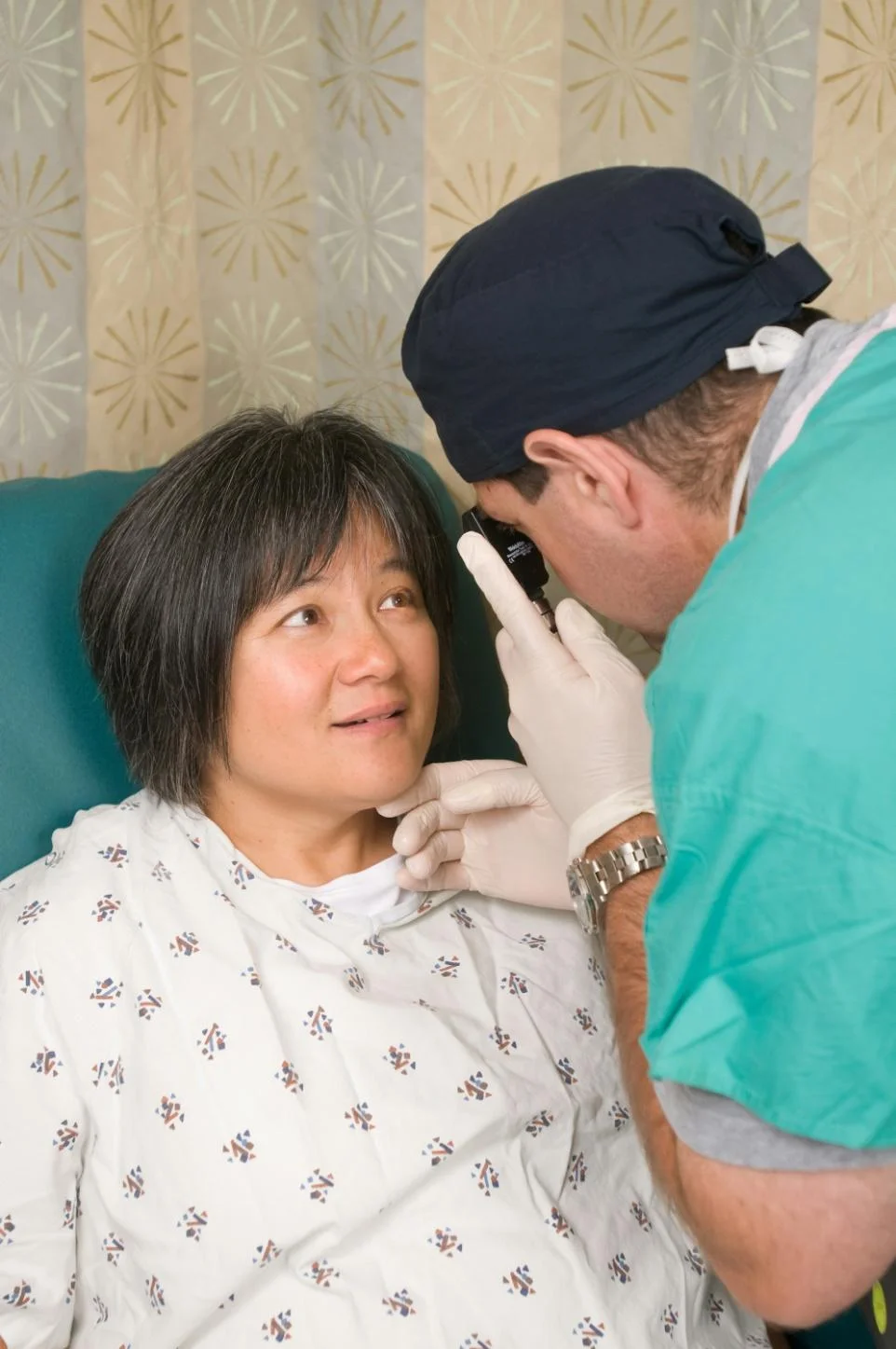 A woman getting her eye checked by a doctor for conjunctivitis