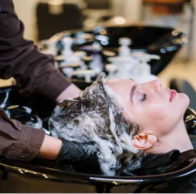 A woman getting her hair shampooed