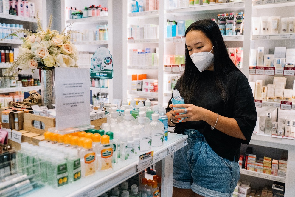 Woman looking at a bottle in a pharmacy