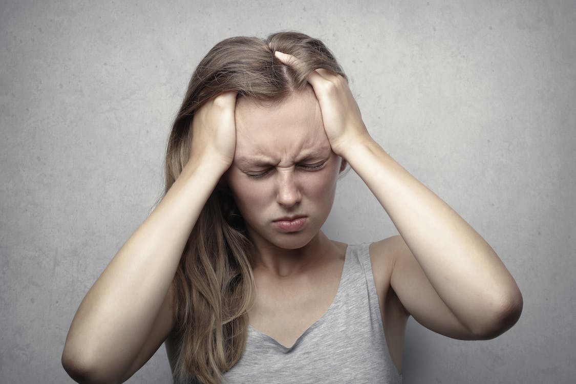 A woman having a headache due to a sinus infection
