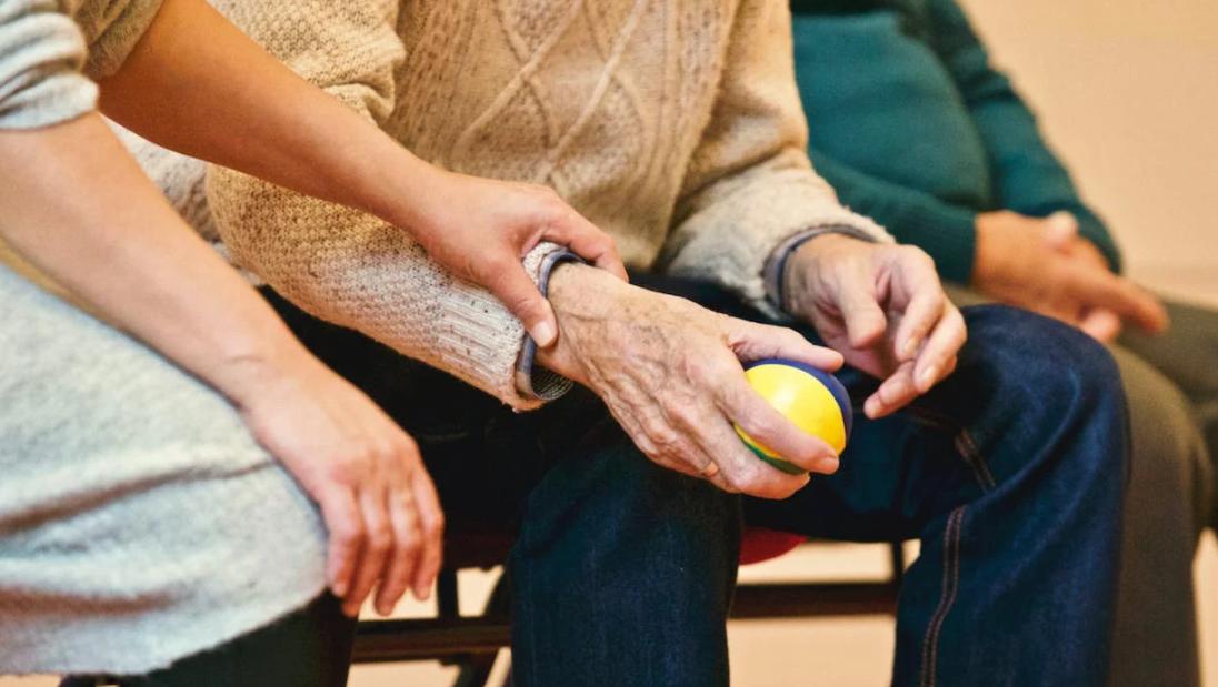 Person holding a stress ball in a support group. 