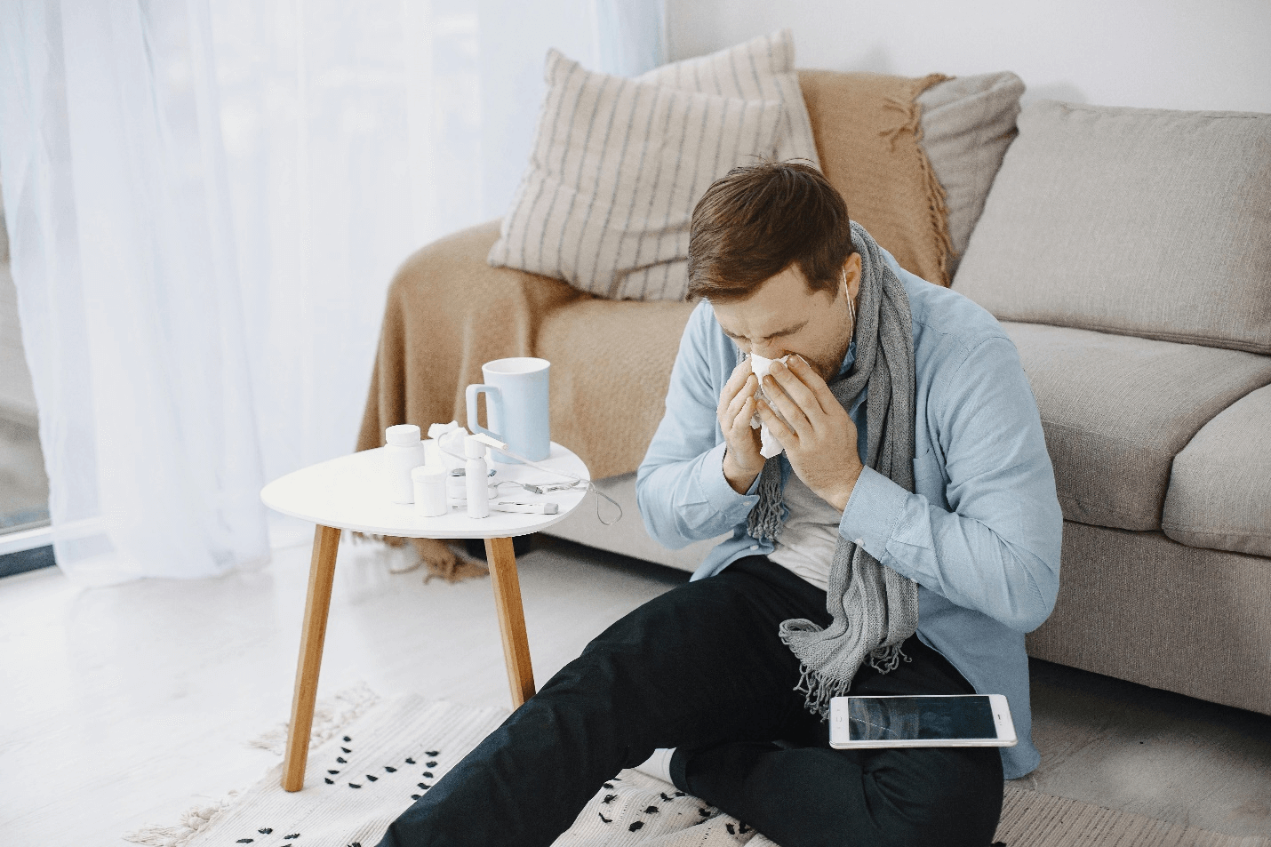 a man blowing his nose with tissue