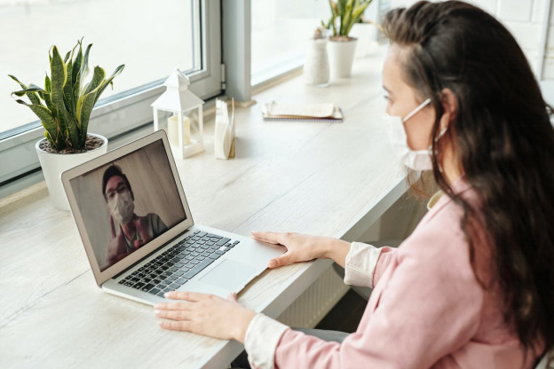 A woman talking to her doctor over via video consultation
