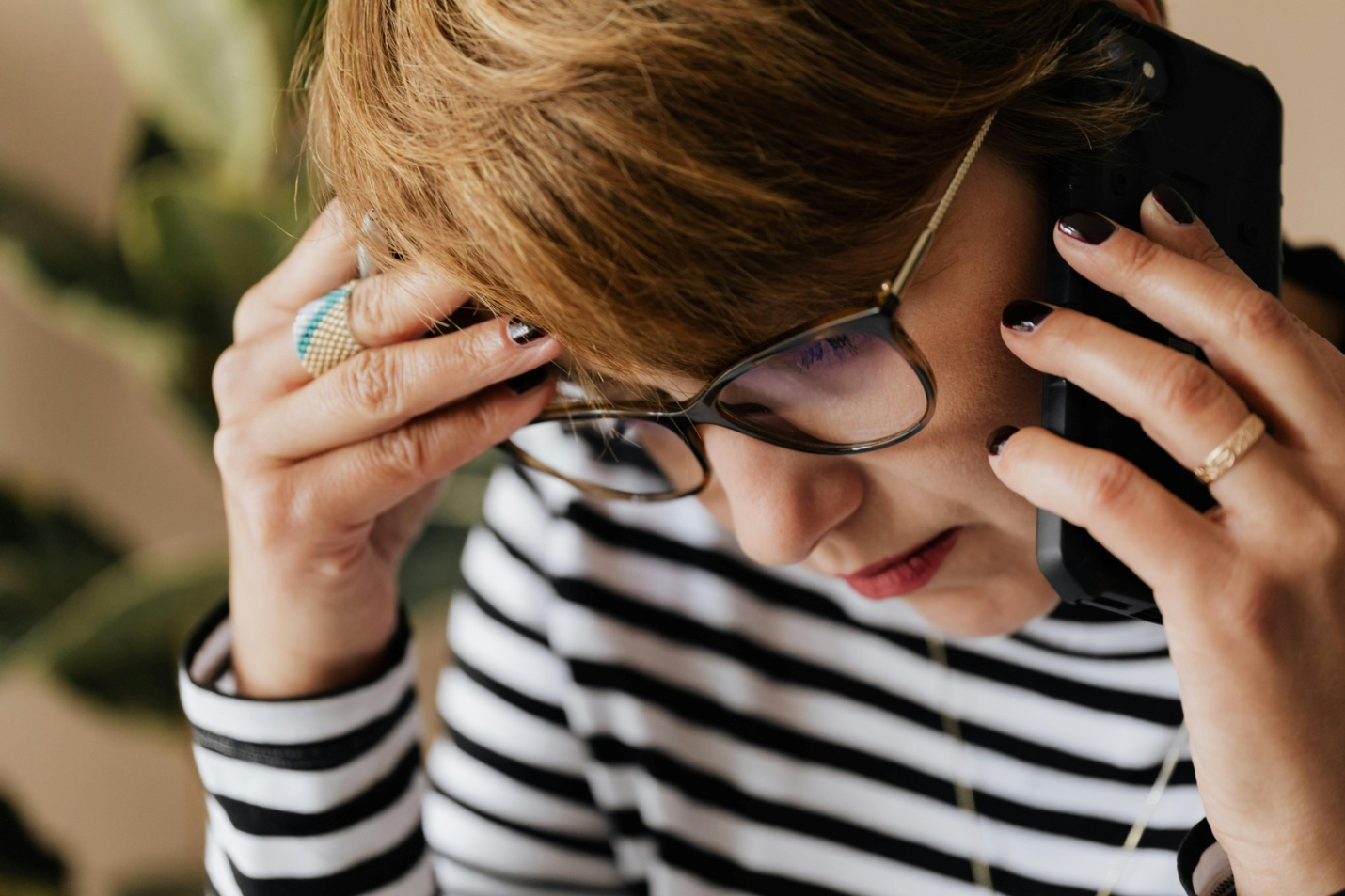 a woman with a headache on the phone