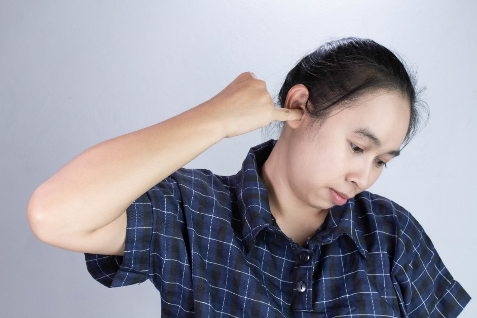 Woman with an itchy ear.