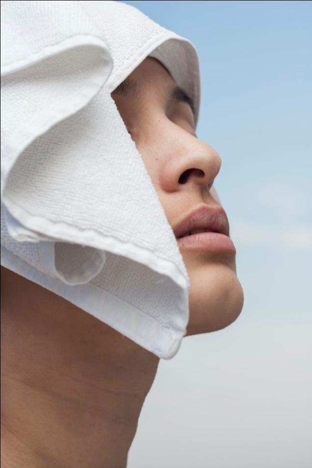 An image of a towel on a woman’s face