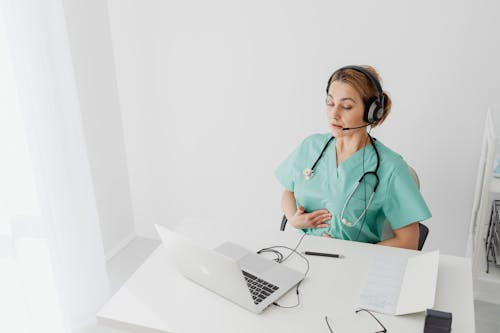Doctor on video call providing virtual medical guidance for a patient from home