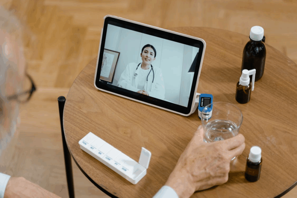Patient speaking with a doctor online, with medications on the table