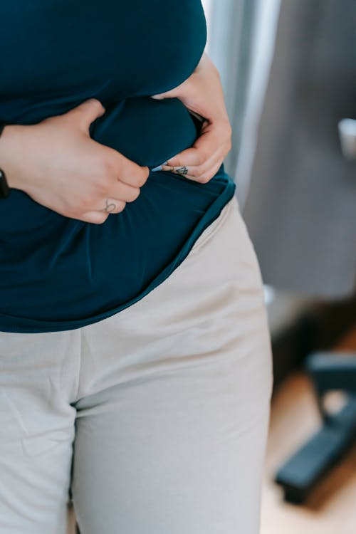 Person holding extra body fat.