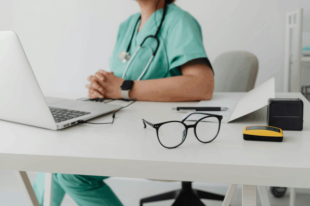 a doctor seated in front of a laptop