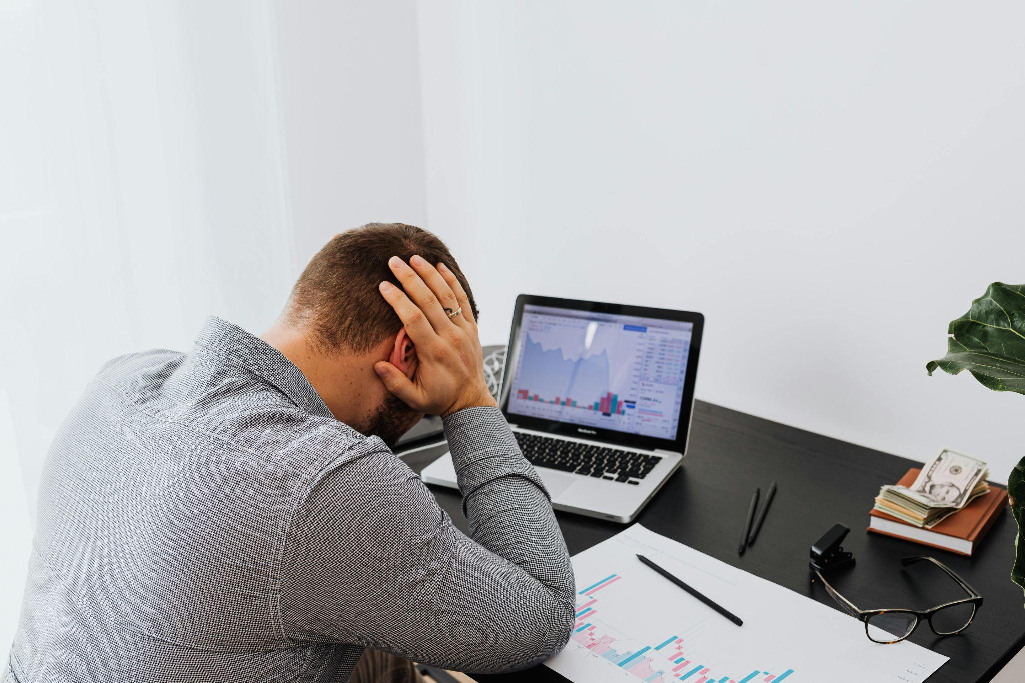 a person holding their head in their hands