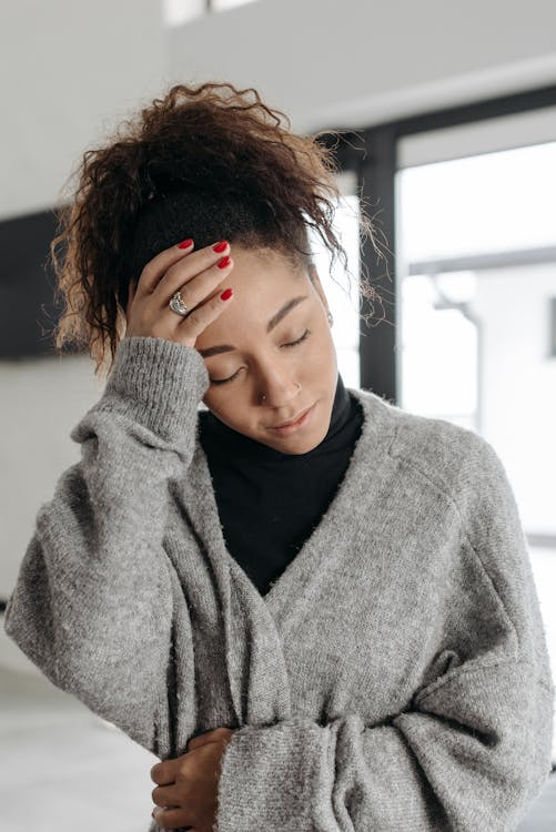 a woman holding her head